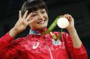 Japan's Kaori Icho celebrates on the podium after winning in the women's 58kg freestyle wrestling event at the Carioca Arena 2 in Rio de Janeiro on August 17, 2016