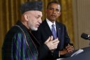 U.S. President Obama listens to Afghan President Karzai during joint news conference at the White House in Washington