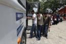 Deportees board a bus outside the Care Center for Returning Migrants (CAMR) after arriving on an immigration flight from the U.S., at the international airport in San Pedro Sula