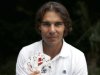 Spanish tennis player Rafa Nadal poses with playing cards depicting some of his 11 Grand Slam victories after an interview with Reuters in Madrid