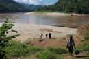 Journalists and researchers walk up to Ban Sob Moei, a Thai village located at the confluence of Moei and Salween rivers, which is threatened by the planned Hatgyi dam in Myanmar