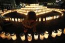 A boy looks at a candle light at a memorial held in remembrance of victims of the March 11, 2011 earthquake and tsunami in Koriyama