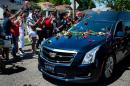 The hearse carrying boxing legend Muhammad Ali drives past his childhood home on June 10, 2016 in Louisville, Kentucky