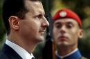 FILE - In this Monday, Dec. 15, 2003 file photo, Syrian President Bashar Assad reviews the presidential guard during a welcoming ceremony in Athens. The tide of global rage against the Islamic State group lends greater urgency to ending the jihadis' ability to operate at will from a base in war-torn Syria. That momentum could also force a reevaluation of what to do about President Bashar Assad's future and puts a renewed focus on the position of his key patrons, Russia and Iran. (AP Photo/Petros Giannakouris, File)