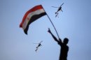 File picture of Egyptian military helicopters trailing national flags circling over Tahrir Square during a protest demanding that Egyptian President Mohamed Mursi resign in Cairo