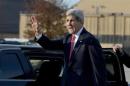 U.S. Secretary of State John Kerry waves before getting into his motorcade vehicle as he arrives at Andrews Air Force Base