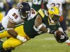 Green Bay Packers Benson is tackled by Chicago Bears Briggs during their NFL football game in Green Bay