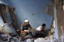 Free Syrian Army fighters take cover inside a damaged house in Deir al-Zor