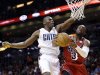 Miami Heat guard Dwyane Wade (3) goes up for a shot against Charlotte Bobcats forward Bismack Biyombo of the Democratic Republic of Congo, during the first half of an NBA basketball game, Monday, Feb. 4, 2013 in Miami. (AP Photo/Wilfredo Lee)