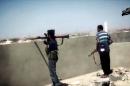 An image from a video made available on October 9, 2014, by the official media outlet of Islamist group Ansar al-Sharia allegedly shows their militants during a battle in Benghazi