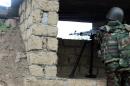 Azeri serviceman aims his weapon at frontline with self-defense army of Nagorno-Karabakh in Azerbaijan