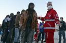 Italian Red Cross personnel prepare to give first aid to shipwrecked migrants as they arrive in the Italian port of Augusta, in Sicily on April 16, 2015