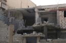 Damage to a house is seen following clashes between rival militias in the Janzour district on the outskirts of Tripoli.