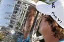 Jason Dufner kisses the Wanamaker Trophy after winning the PGA Championship golf tournament at Oak Hill Country Club, Sunday, Aug. 11, 2013, in Pittsford, N.Y. (AP Photo/Julio Cortez)