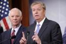 Sen. Lindsey Graham, R-S.C., right, speaks during a news conference on the violence in the Mideast on Capitol Hill in Washington, Thursday, July 24, 2014. At left is Sen. Ben Cardin, D-Md., left. (AP Photo)