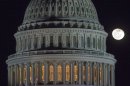 The moon rises behind the U.S. Capitol Dome in Washington as Congress works into the late evening, Sunday, Dec. 30, 2012 to resolve the stalemate over the pending "fiscal cliff." (AP Photo/J. David Ake)