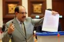 Nuri al-Maliki casts his vote at a polling station in Baghdad's fortified Green Zone on April 30, 2014