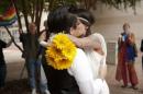 Amanda Scott and Christina Corvin kiss after getting married outside of the Mecklenburg County Register of Deeds office in Charlotte