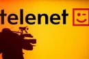 The shadow of a cameraman is seen beside the Belgian cable operator Telenet logo during a news confe..