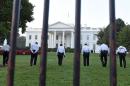 Uniformed Secret Service officers walk along the lawn on the North side of the White House in Washington, Saturday, Sept. 20, 2014. The Secret Service is coming under intense scrutiny after a man who hopped the White House fence made it all the way through the front door before being apprehended. (AP Photo/Susan Walsh)