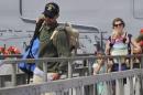 Eric and Charlotte Kaufman and their two daughters, 3-year-old Cora and 1-year-old Lyra, disembark the USS Vandegrift in San Diego