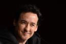 John Cusack will play a former Wall Street trader in the drama pilot he is producing for CBS.