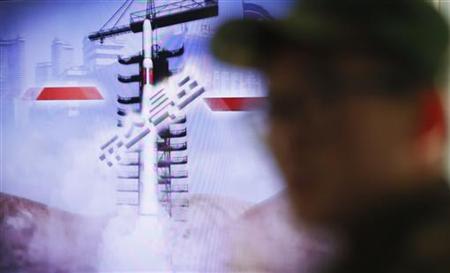 A South Korean soldier watches a television report on North Korea's rocket launch, at Seoul railroad station in Seoul December 12, 2012. REUTERS/Lee Jae-Won