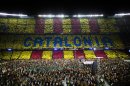 In this photo taken on June. 29, 2013, supporters make a mosaic with the words of Catalonia as they attend to a pro-independence festival in the Nou Camp stadium in Barcelona, Spain. The Spanish region of Catalonia is set to see possibly its largest ever pro-independence rally on Wednesday when organizers are hoping to surpass the around one million people who took to streets of Barcelona last year, many of whom called for a free state. Besides the traditional march in Barcelona held on the regional holiday of Sept. 11, a pro-independence grass roots group has organized a human chain stretching for over 400 kilometers north and south across the economically powerful northeastern region. (AP Photo/Emilio Morenatti)