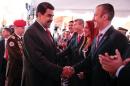 Venezuela's President Nicolas Maduro shakes hands with Venezuela's new Vice-President Tarek El Aissami during a meeting with ministers at 4F military fort in Caracas