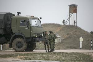 Russian soldiers stand near a military vehicle at Belbek …