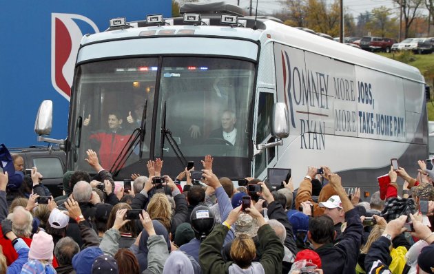 Republican vice presidential candidate, Rep. Paul Ryan, R-Wis., left in front of bus, gives a thumbs-up to supporters as he arrives for a campaign rally at the Valley View Campgrounds in Belmont, Ohio, Saturday, Oct. 20, 2012, where he talked about economic conditions and the coal industry. (AP Photo/Keith Srakocic)