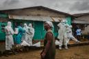 A photo courtesy of The New York Times shows a relative grieving as a burial team prepares to remove the body of Ofori Gweah, who died of Ebola's telltale symptoms, in Monrovia. Daniel Berehulak was awarded the 2015 Pulitzer for feature photography