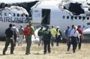 U.S. National Transportation Safety Board investigators work at the scene of the Asiana Airlines Flight 214 crash site at San Francisco International Airport in San Francisco