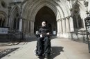Pro-euthanasia campaigner Paul Lamb poses for photographs as he leaves the High Court in London