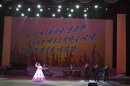A North Korean musical performance is held in Pyongyang with the words "Let's strike the imperialists mercilessly with the same success we had carrying out the 3rd nuclear test" projected on a screen, on Sunday, Feb. 17, 2013. (AP Photo/David Guttenfelder)