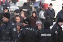 Migrants are seen in front of Bulgarian police after clashes inside a refugee center in the town of Harmanl