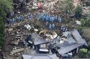 Rescue workers conduct a search and rescue operation to a collapsed house at a landslide site caused by earthquakes in Minamiaso town, Japan