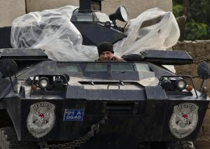 A man uses a cell phone sitting in a Turkish armored …