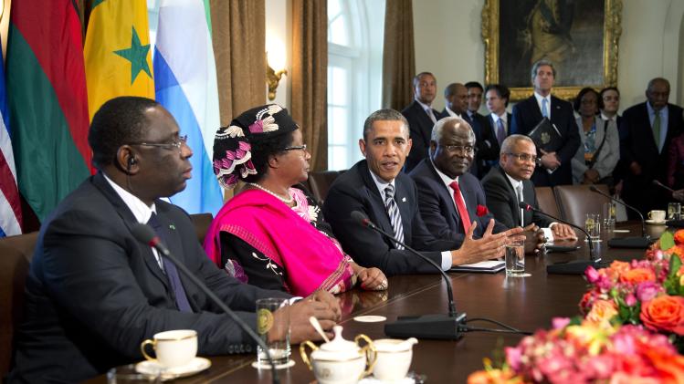 FILE In this March 28, 2013 file photo, President Barack Obama speaks in the Cabinet Room of the White House in Washington, after a meeting with, from left, Senegal President Macky Sall; Malawi President Joyce Banda; Sierra Leone President Ernest Bai Koroma; and Cape Verde Prime Minister José Maria Pereira Neves. The U.S. embassy in Abidjan, Ivory Coast made history in June 2013 by hosting a gay pride reception attended by about two dozen openly gay Ivorians. Despite the groundbreaking nature of the event, reporters were barred from attending, and the only mention of it was a short blurb on the embassy website posted the following week. The discreet handling of the event encapsulates the Obama administration's cautious promotion of gay rights in Africa, an issue that is likely to come up during his visit, beginning June 26, 2013 to three African nations, two of which punish homosexuality with jail time. (AP Photo/Manuel Balce Ceneta, File)