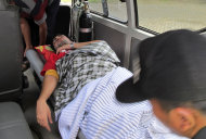 An asylum seekers who survived a wreck is taken into an ambulance in Trenggalek, East Java, Indonesia, Sunday, Dec. 18, 2011. Rescuers battled high waves Sunday as they searched for asylum seekers still missing after their wooden ship sank off Indonesia's main island of Java. (AP Photo)