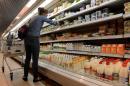 File photo shows a woman looking at dairy products in a supermarket in central Moscow on August 5, 2013