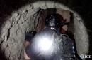 This image released by the US Immigration and Customs Enforcement (ICE), Homeland Security agent enters the interior of the tunnel on October 31, 2013