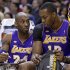 Los Angeles Lakers guard Kobe Bryant, left, draws a play for center Dwight Howard as they sit on the bench in the first half of an NBA basketball game against the Indiana Pacers in Indianapolis, Friday, March 15, 2013.  (AP Photo/Michael Conroy)