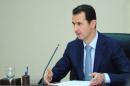 Syria's President Bashar al-Assad heads a meeting of his new cabinet in Damascus