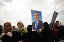 Supporters of Yemen's former President Ali Abdullah Saleh hold posters of Saleh outside the al-Saleh mosque after weekly Friday prayers in Sanaa