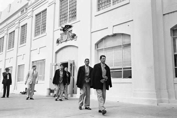 In this March 21, 1963 photo taken by Leigh Wiener and provided by the National Park Service, prison guard Jim Albright, second from left, leads out the last prisoners from the federal penitentiary. The National Park Service on Thursday celebrated the 50th anniversary of Alcatraz Island's closure as a federal penitentiary with an exhibit of newly discovered photos of the prison's final hours. The new display opened five decades after the last shacked prisoners were taken off the infamous prison in San Francisco Bay that once held the likes of gangsters Al Capone and Mickey Cohen. (AP Photo/National Park Service, Copyright Leigh Wiener)