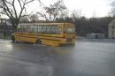 In this photo released by the Baltimore County Police, a school bus sits in a sinkhole, Wednesday, Jan. 6, 2015, in Cockeysville, Md. Baltimore County police say a school bus carrying high school students got stuck in a sinkhole after an overnight water main break, but the students got off safely. Police said in social media posts that the bus carrying Dulaney High School students got stuck Wednesday morning along Cranbrook Road in Cockeysville, near the water main break. (Baltimore County Police via AP)