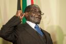 Zimbabwe's President Robert Mugabe clinches his fist while shouting "Amandla" (Power in Xhosa and Zulu) during the signing of various memorandum of understanding with South Africa at the Union Buildings in Pretoria on April 8, 2015