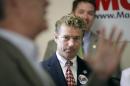 Sen. Rand Paul, R-Ky., listens as he is introduced to speak by Iowa Republican congressional candidate Rod Blum, left, during a meeting with local Republicans, Aug. 5, 2014, in Hiawatha, Iowa. (AP Photo/Charlie Neibergall)