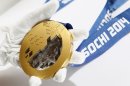 A gold medal manufactured for the 2014 Winter Olympic Games in Sochi, is seen on display at the Adamas jewellery factory in Moscow